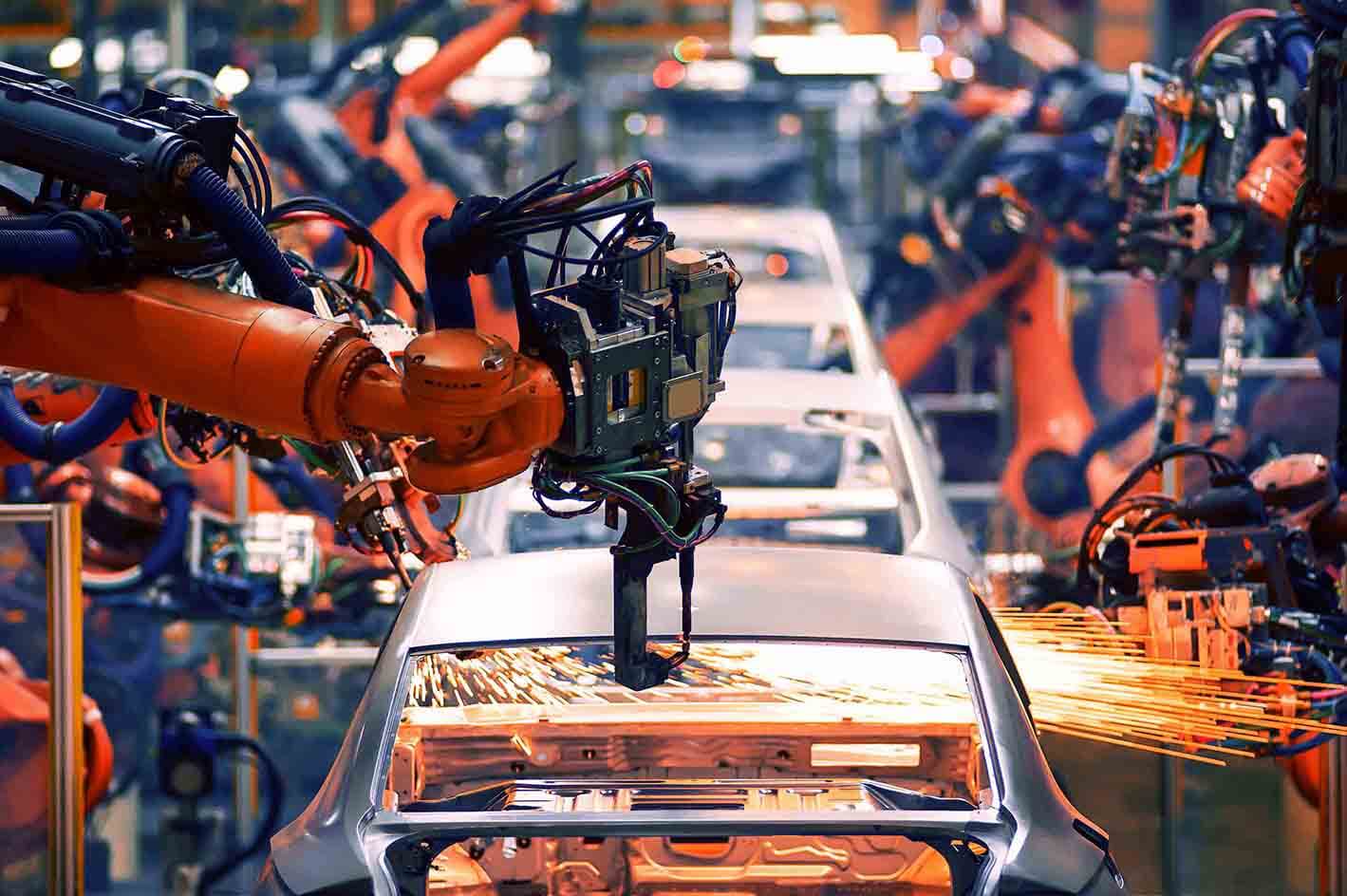 robot arms working in a car manufacturing plant